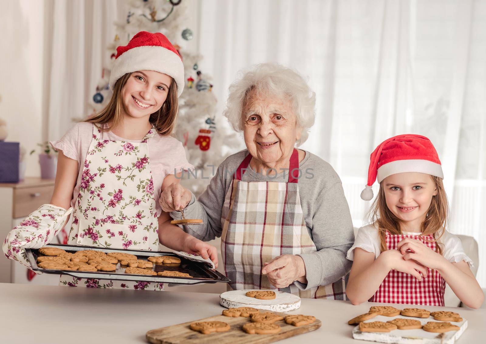 Grandmother with granddaughters baking cookies by tan4ikk1