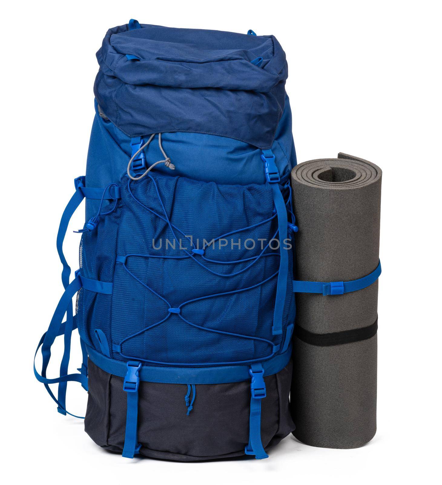 Blue hiking backpack with fitness mat isolated on white background