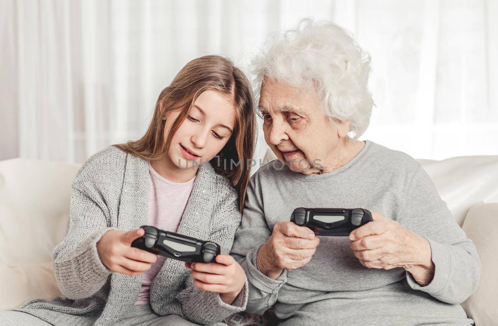 Granddaughter showing grandmother gamepad controls