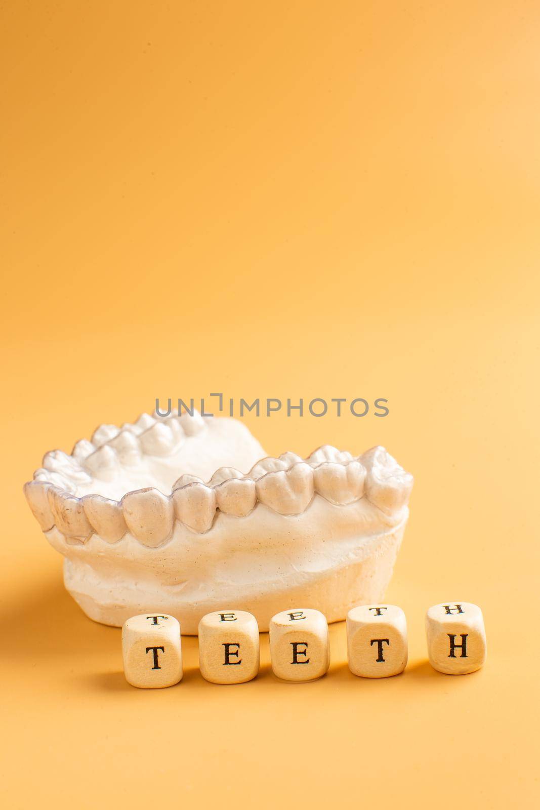 Close-up individual tooth tray Orthodontic dental theme. In hand Invisible braces by Maximusnd