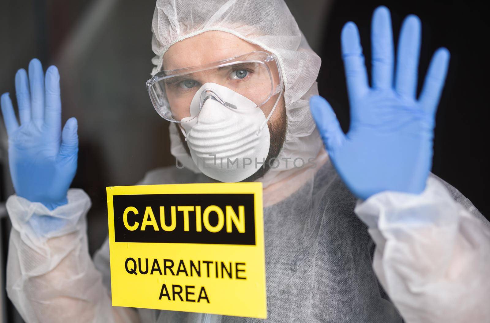 Man in protective white overalls, mask and glasses on his face. Coronavirus, pandemic, flu and quarantine concept