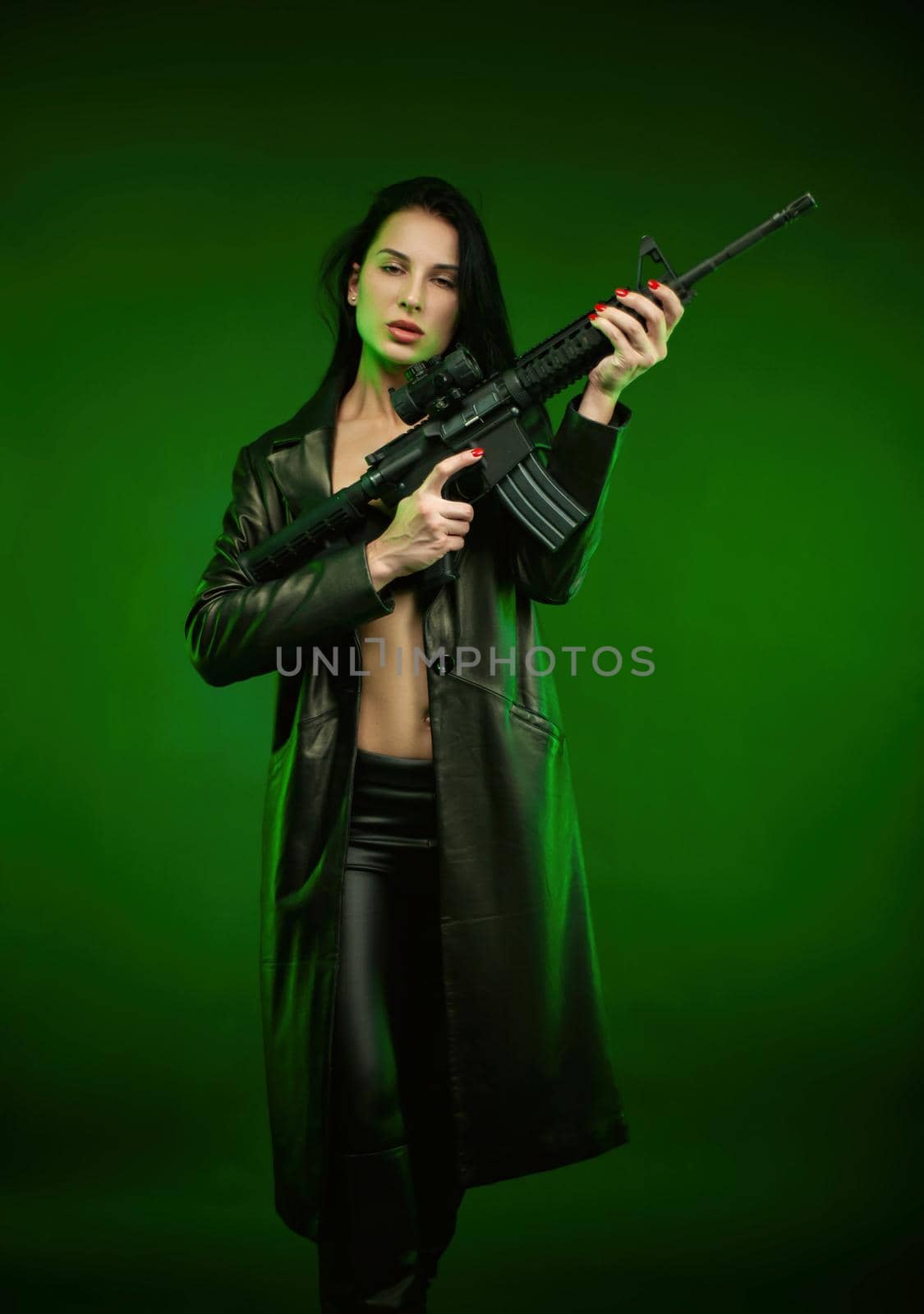 a woman in a black leather raincoat with an American automatic rifle on a green background by Rotozey