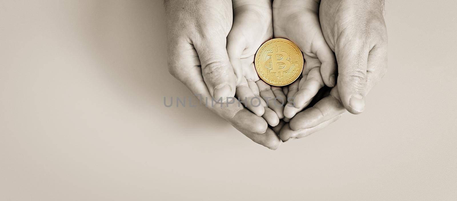 Hands holding bitcoin, world bitcoin day, investing in future children, stability during coronavirus, family investment, corporate social responsibility, investment concept by Maximusnd