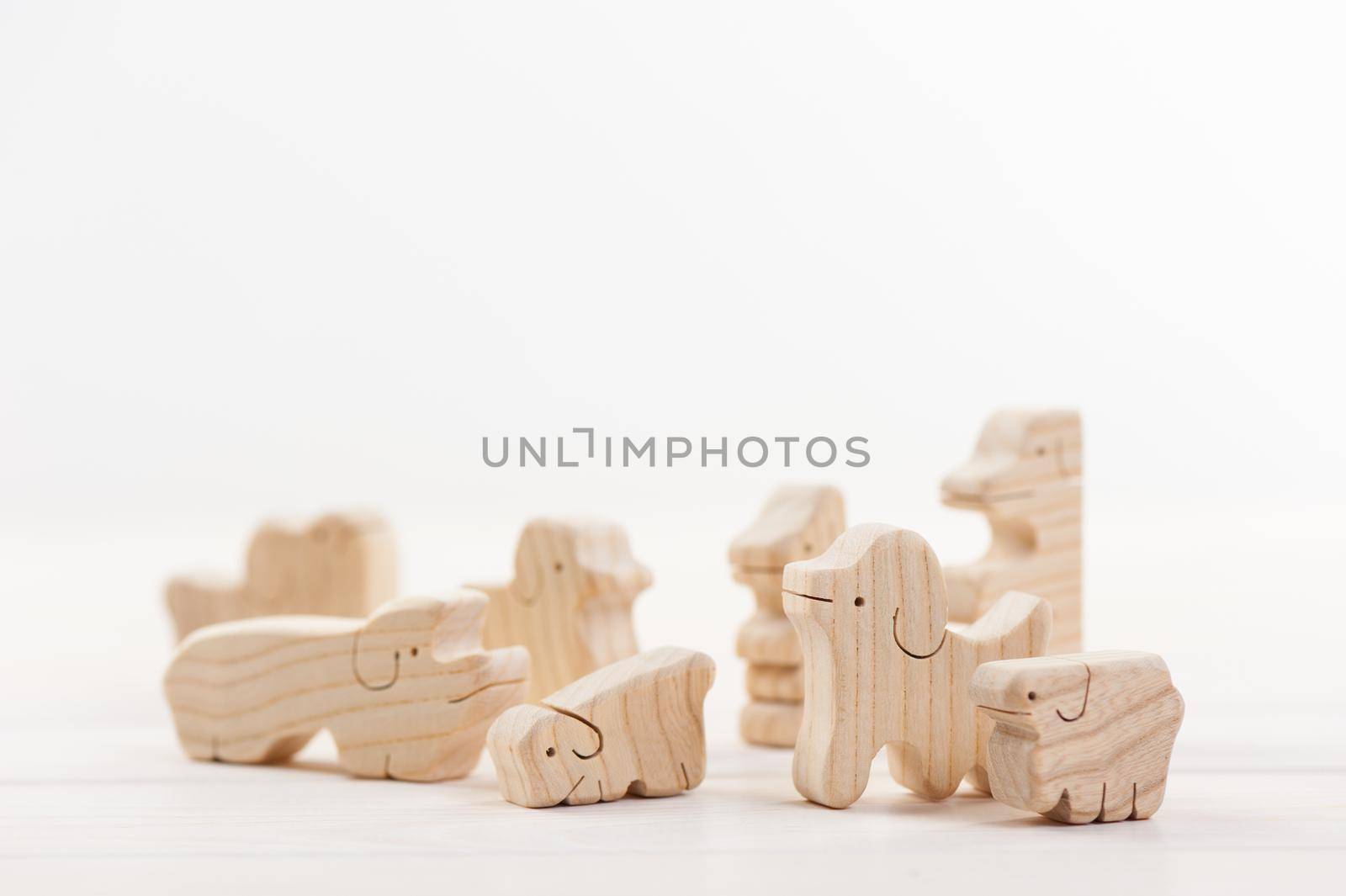 cute wooden toy animal over white background, tiny toys and shallow depth of field