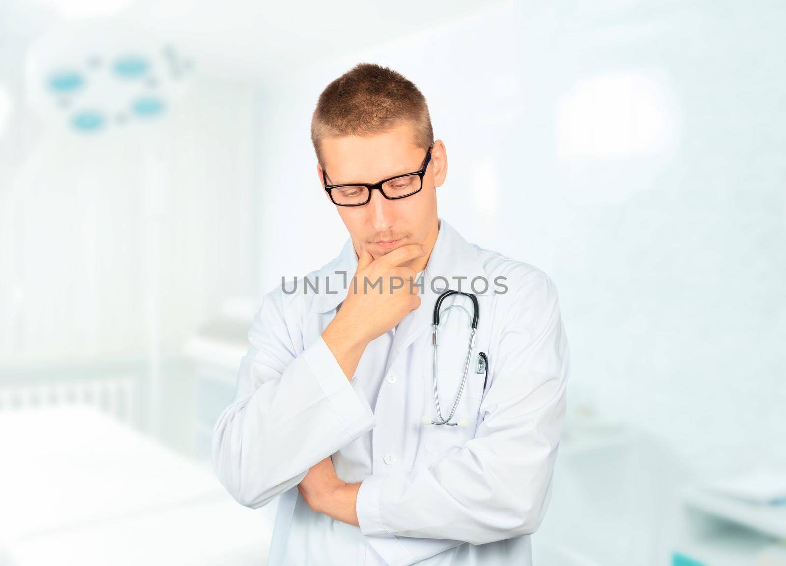 Serious man physician is thinking in a hospital