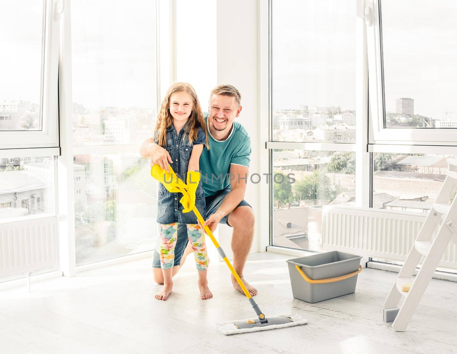 Little girl with father cleaning the floor by tan4ikk1