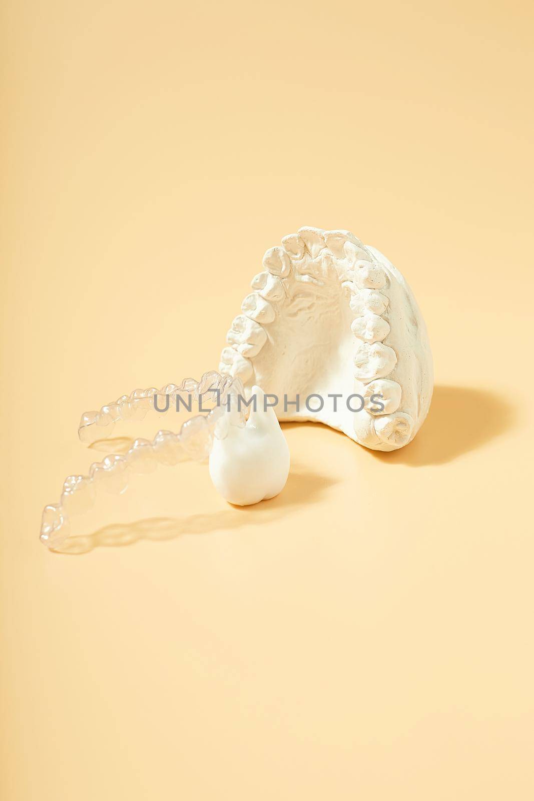 Orthodontic dental theme on  yellow background.Transparent invisible dental aligners or braces aplicable for an orthodontic dental treatment