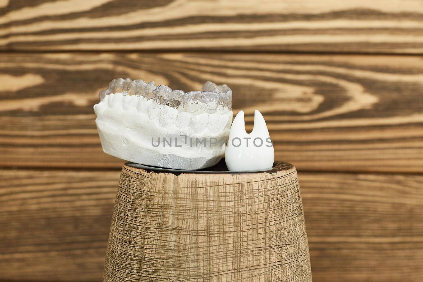 Orthodontic dental theme on a rustic background. Transparent invisible trays or braces for orthodontic dental treatment.