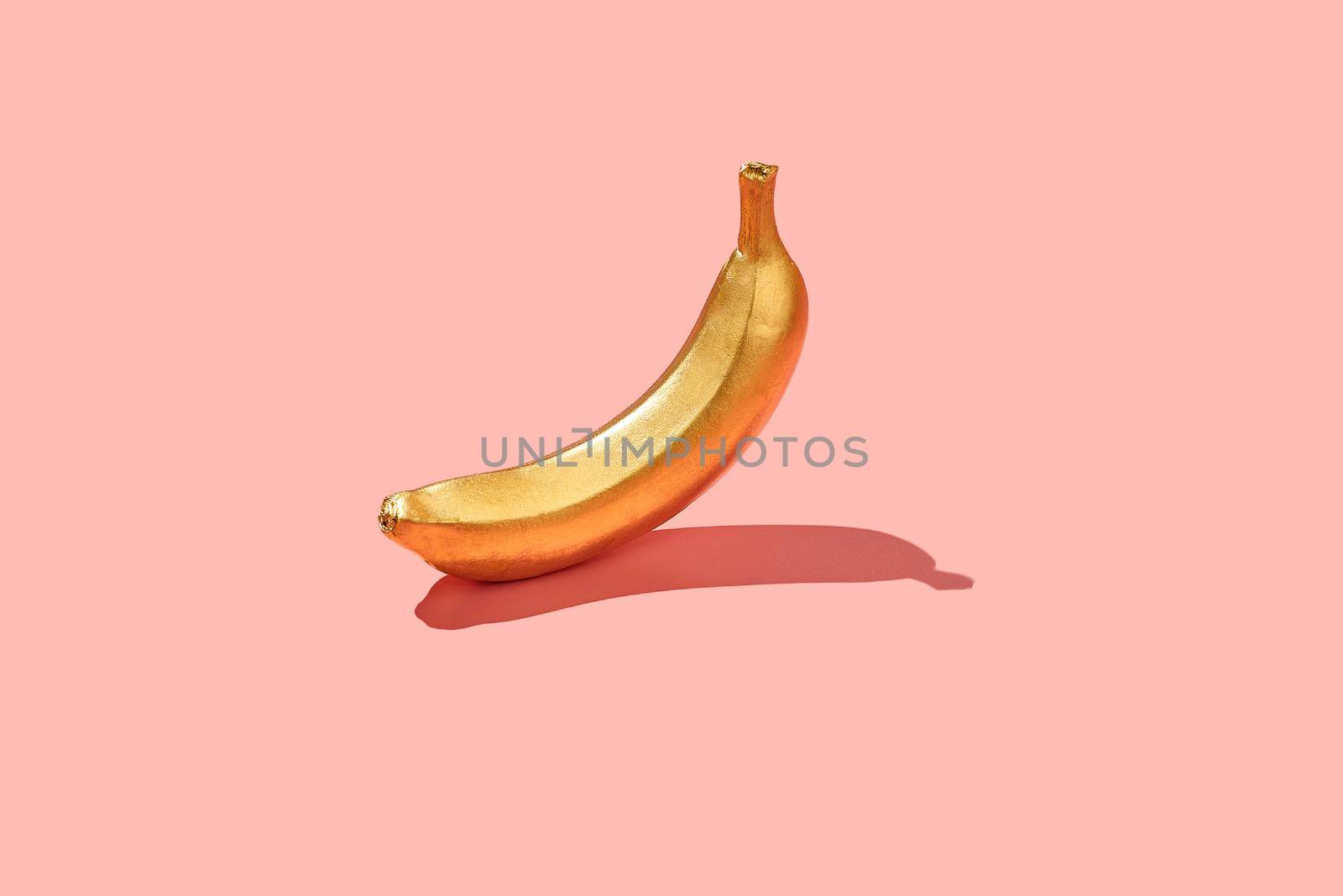 Trendy sunlight Summer , made with yellow banana  on bright light pink background. Minimal summer concept.