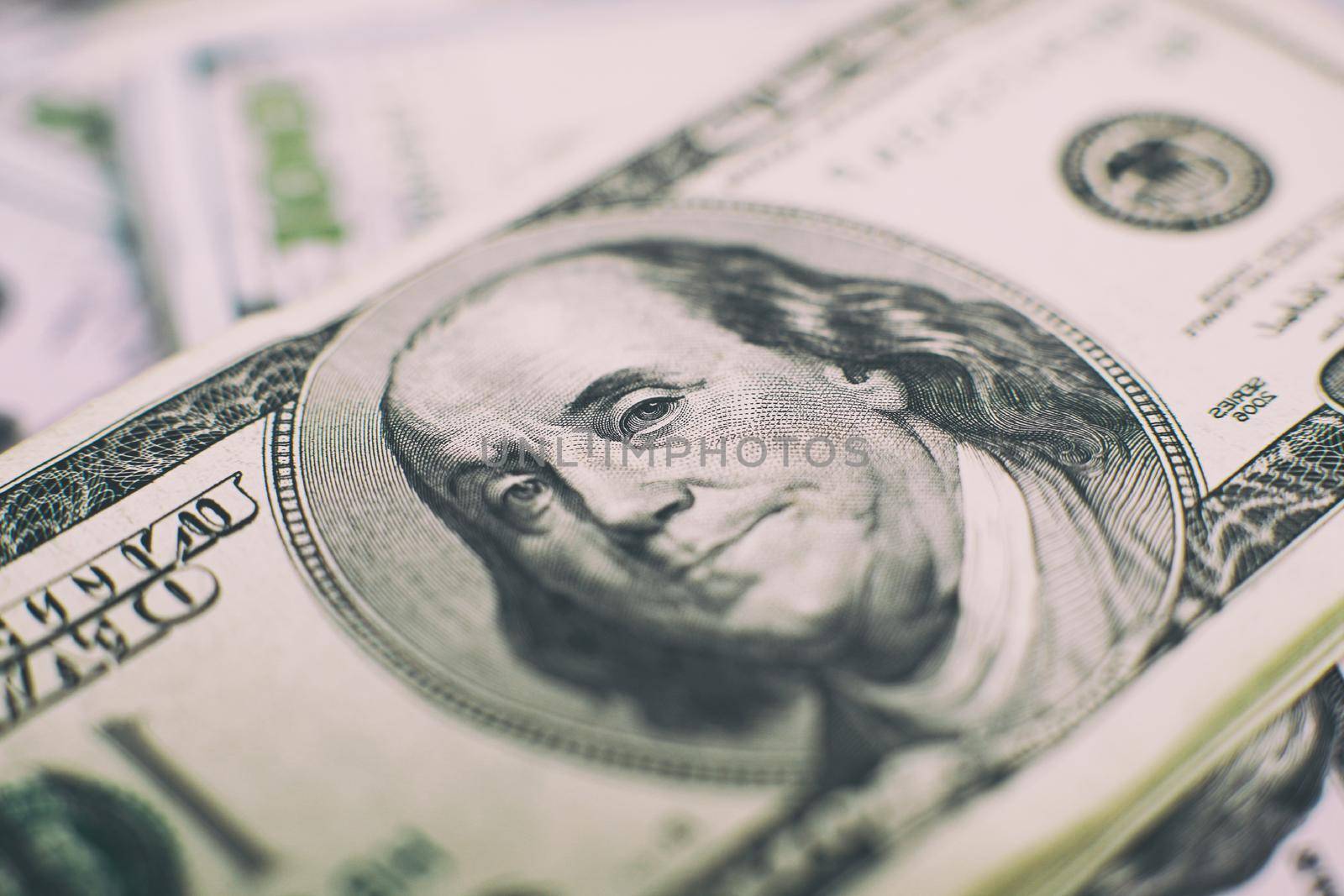 Heap of one hundred dollar bills on money background. Shallow depth field. Selective focus. by Maximusnd