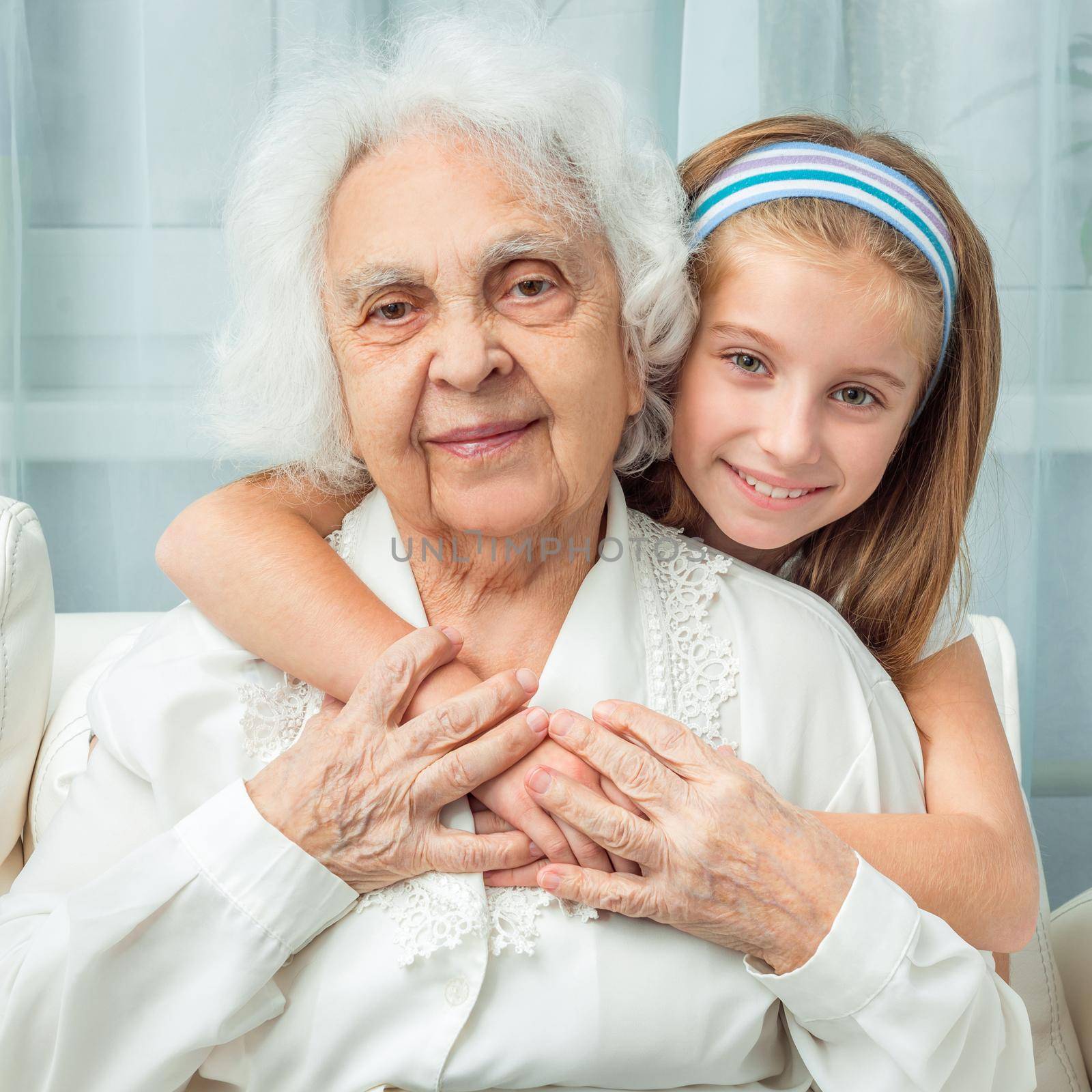 smiling little girl embracing grandmother