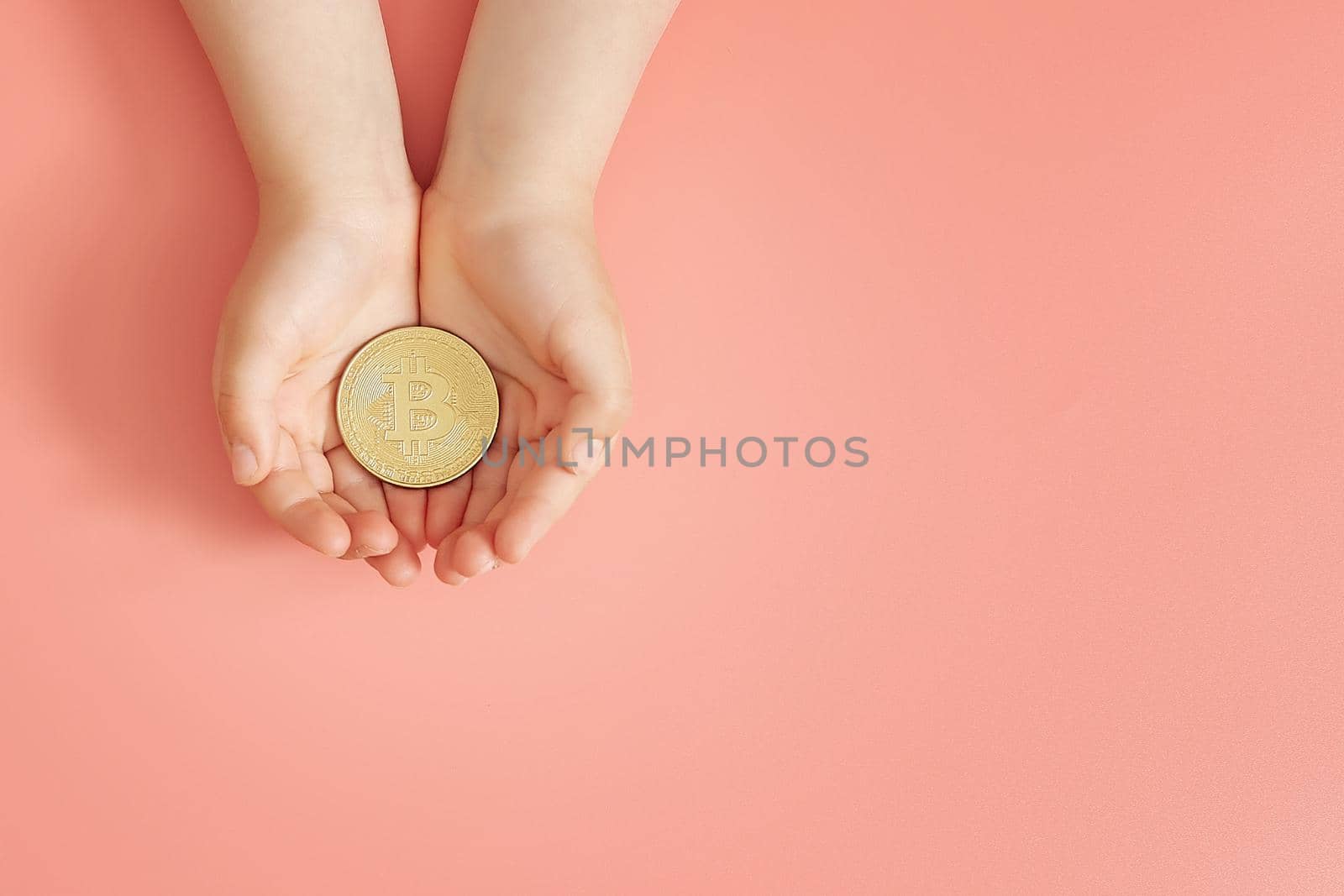 Hands holding bitcoin, world bitcoin day, investing in future children, stability during coronavirus, family investment, corporate social responsibility, investment concept