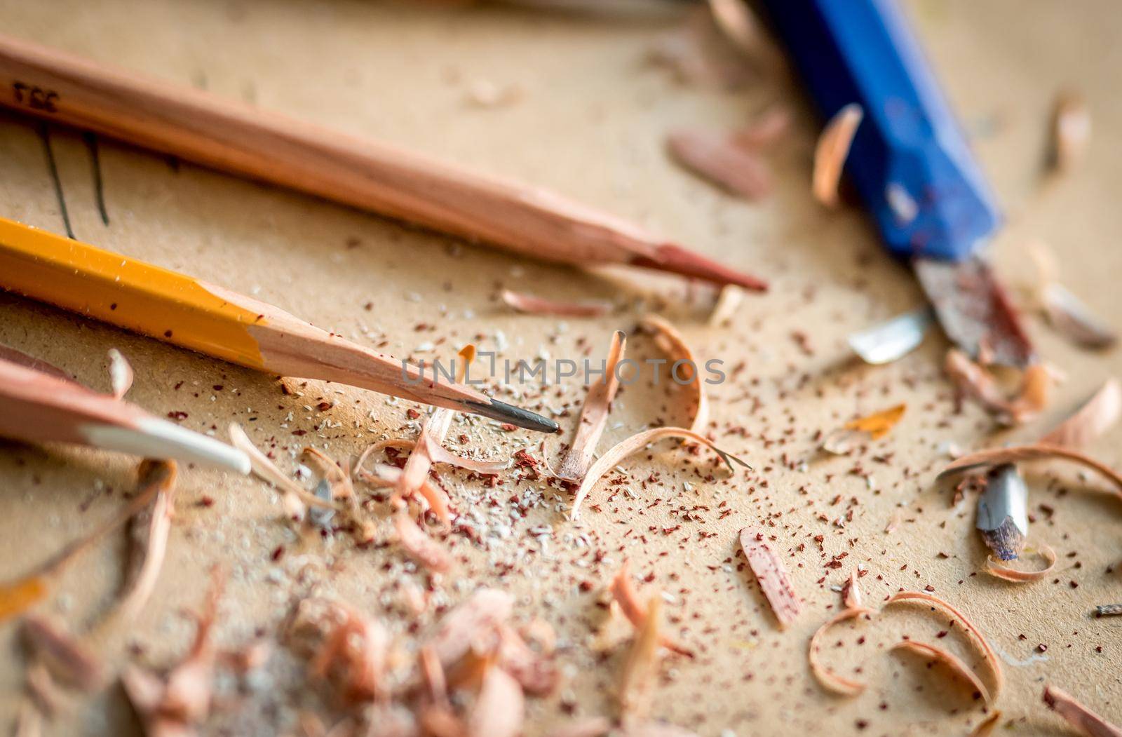 Close-up of graphite graphic pencils with wooden chips, soft focus