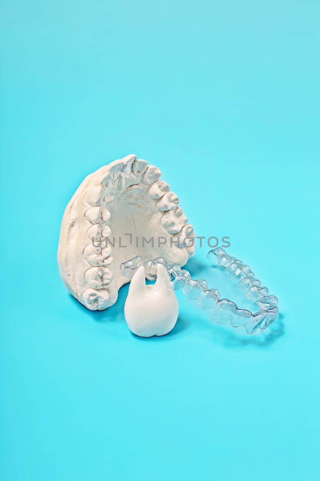 Orthodontic dental theme on blue background. Transparent invisible dental aligners or braces aplicable for an orthodontic dental treatment