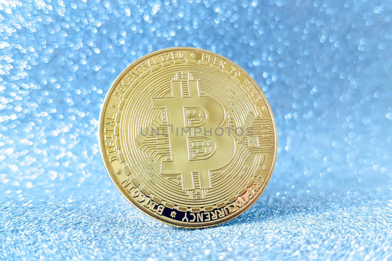 Bitcoin gold coin and defocused glitter background