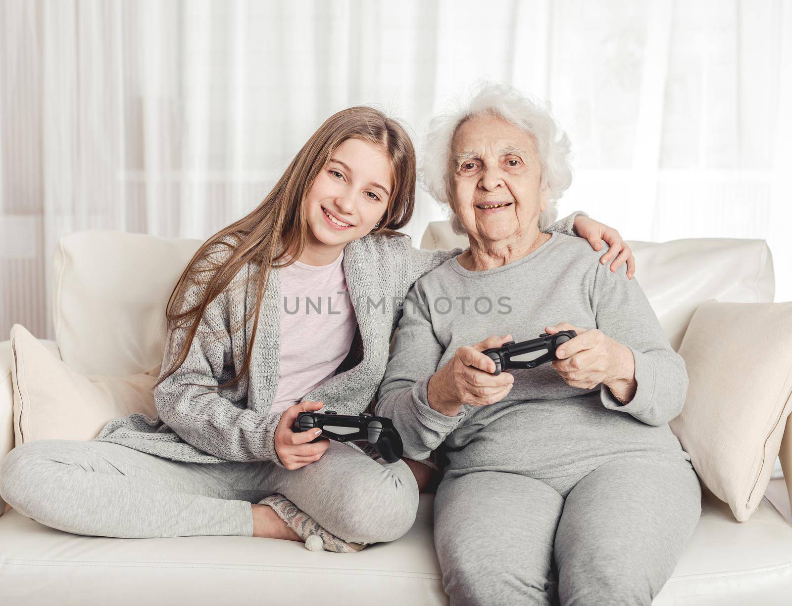 Grandmother with granddaughter playing games by tan4ikk1