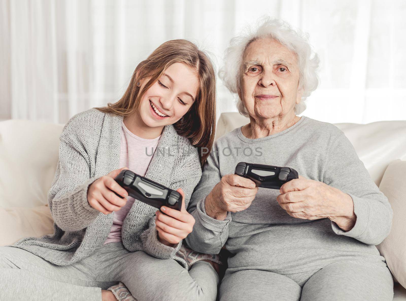 Grandmother with granddaughter playing games by tan4ikk1