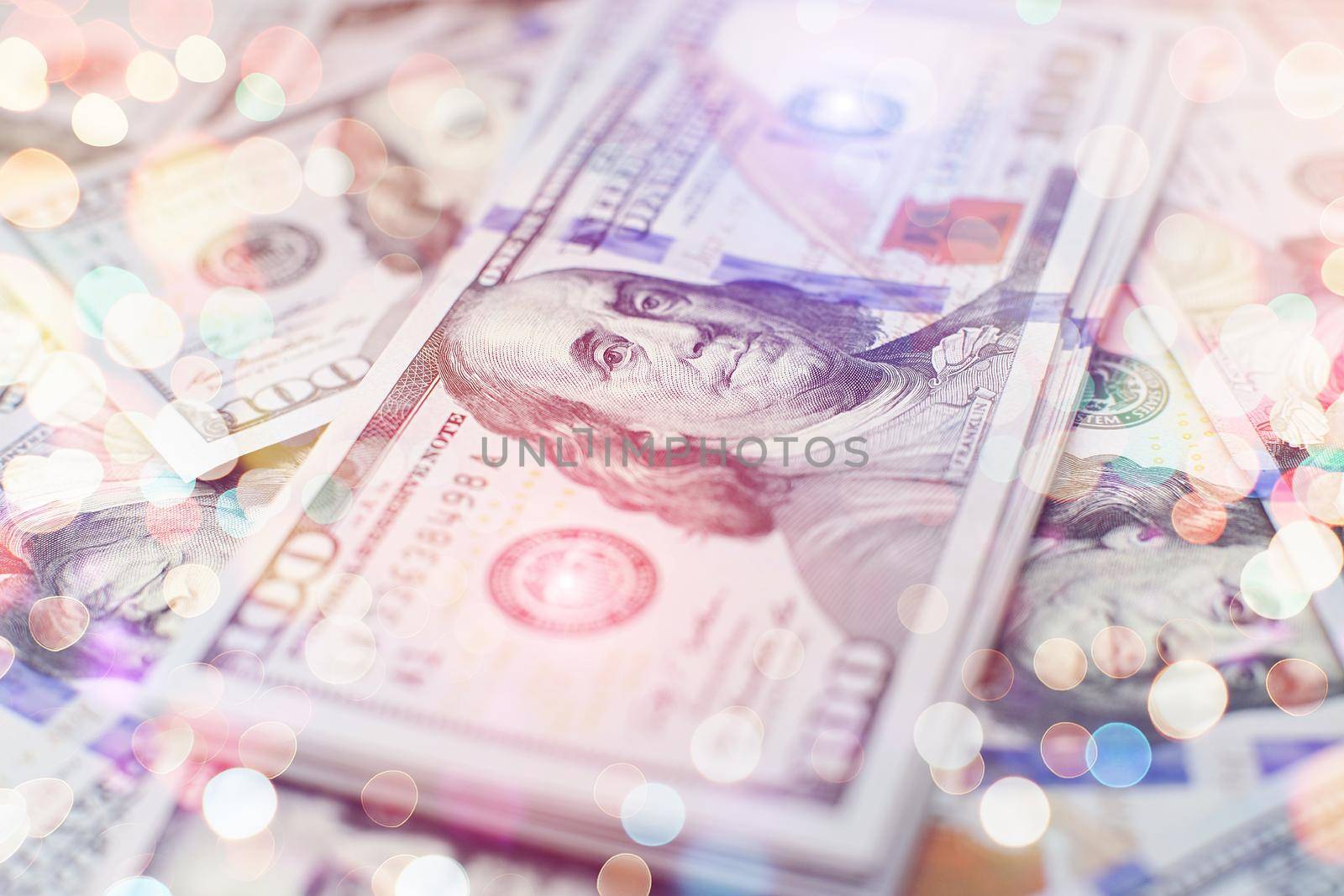 A stack of money. Heap of one hundred dollar bills on money background. Fake money. Shallow depth of field. Selective focus.