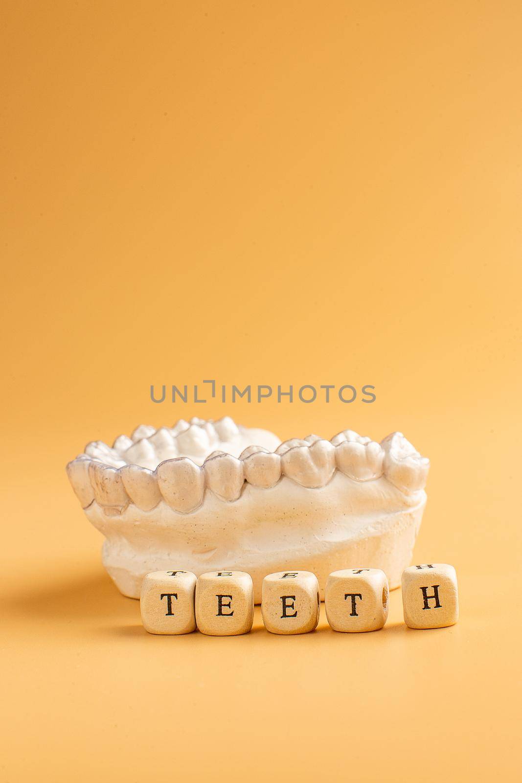 Close-up individual tooth tray Orthodontic dental theme. In hand Invisible braces by Maximusnd