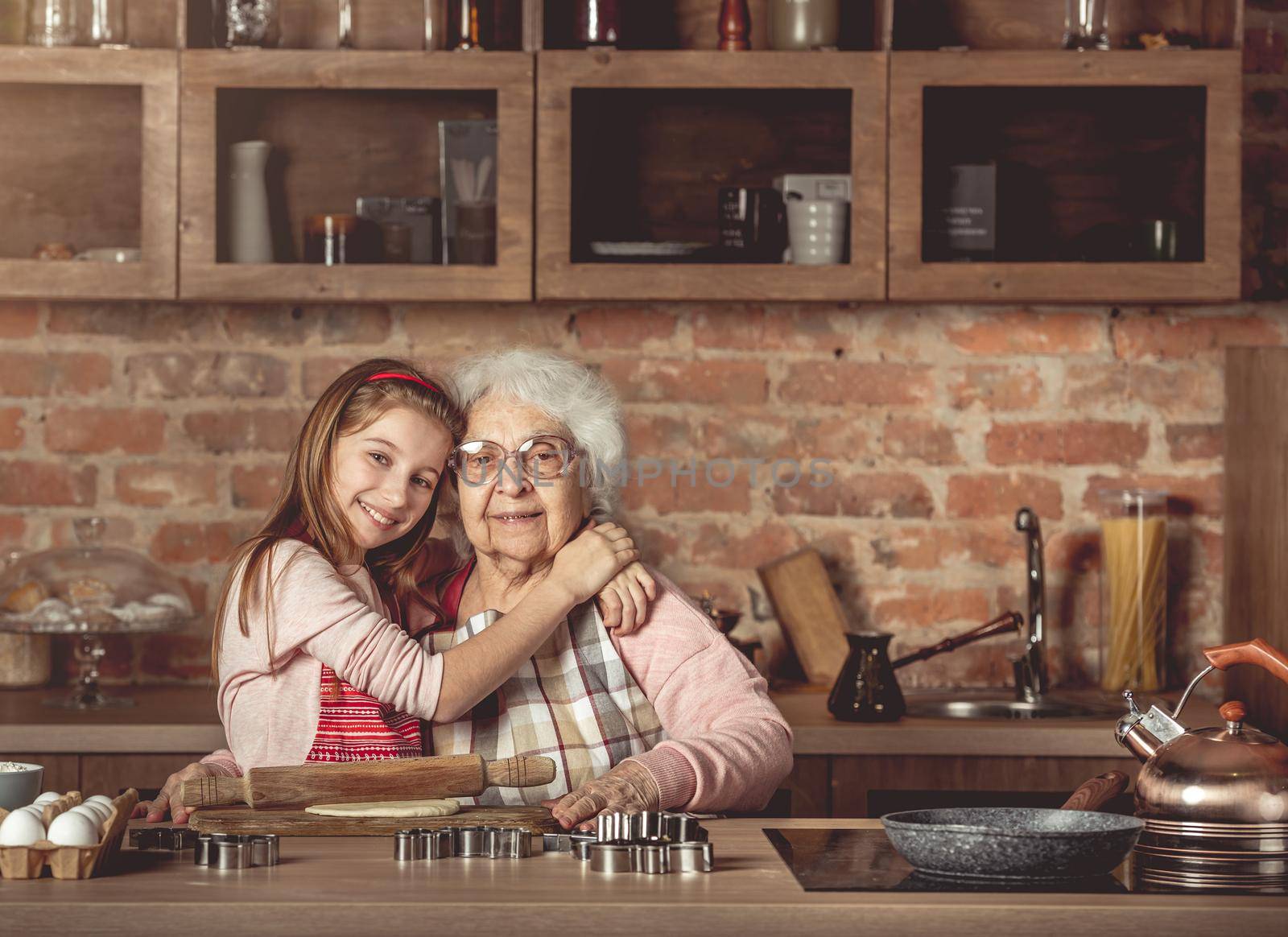 Granddaughter hug her happy grandmother by tan4ikk1