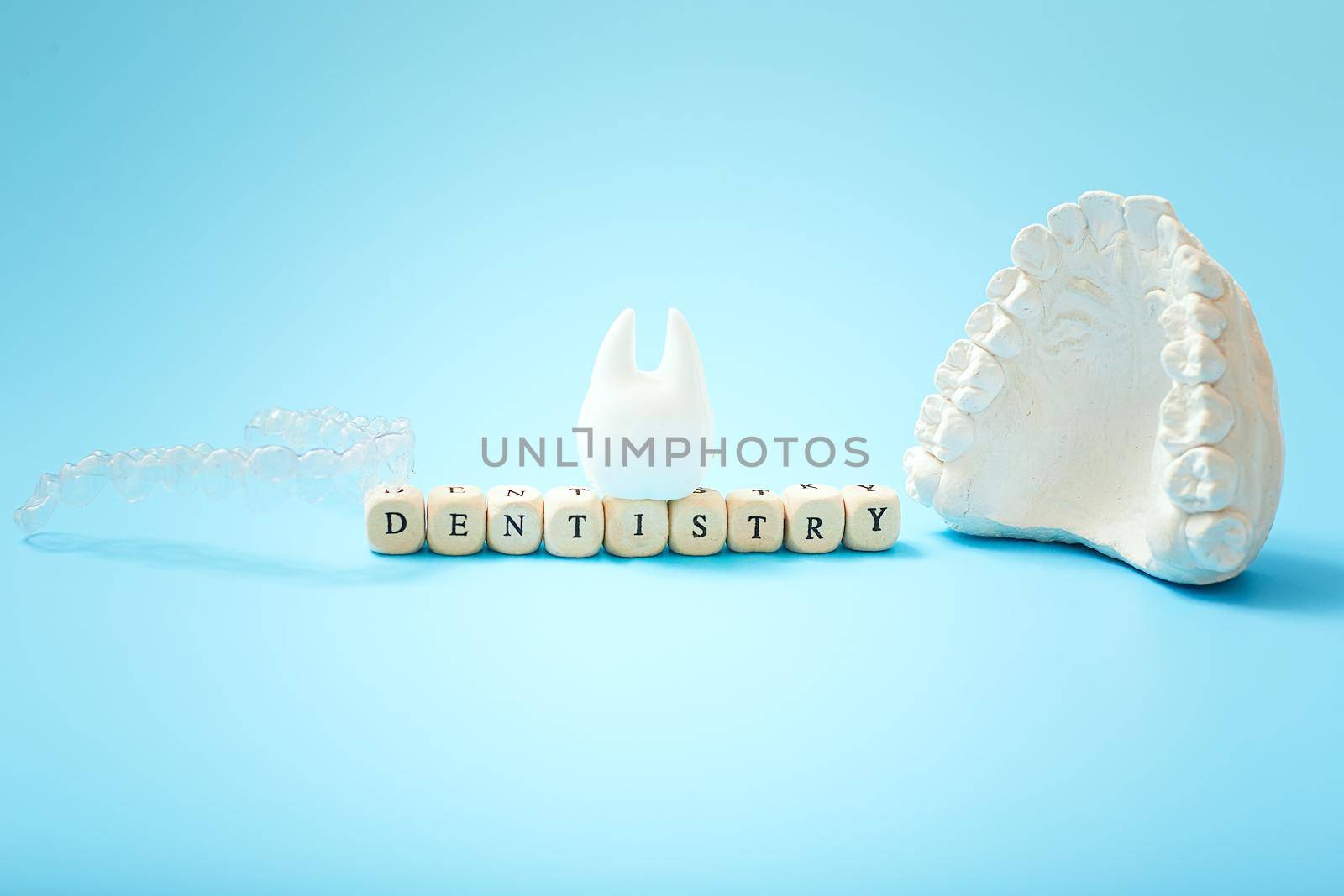 Dentist lettering for your advertisement on a blue background with invisible dental aligners or braces aplicable for an orthodontic dental treatment by Maximusnd