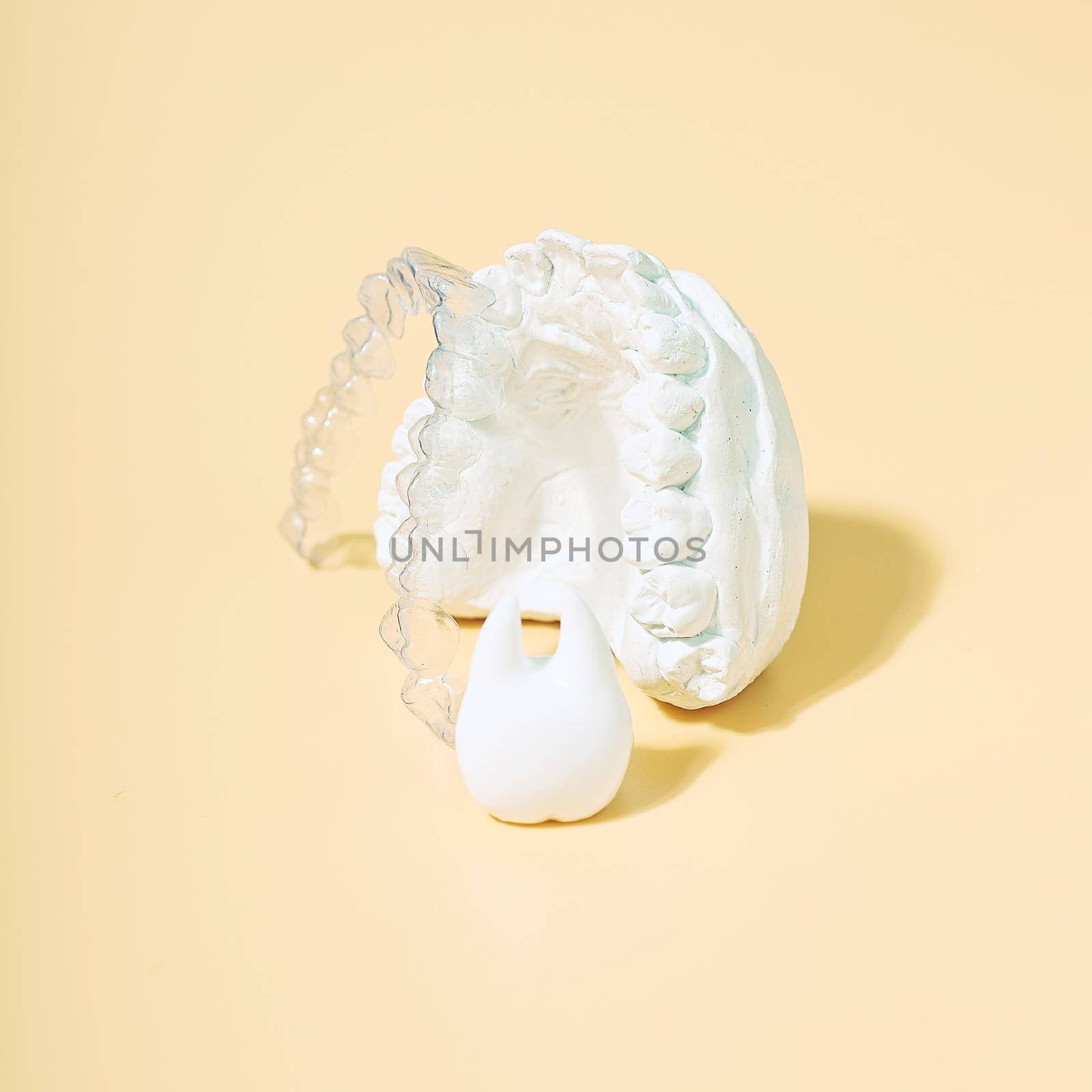 Orthodontic dental theme on  yellow background.Transparent invisible dental aligners or braces aplicable for an orthodontic dental treatment by Maximusnd