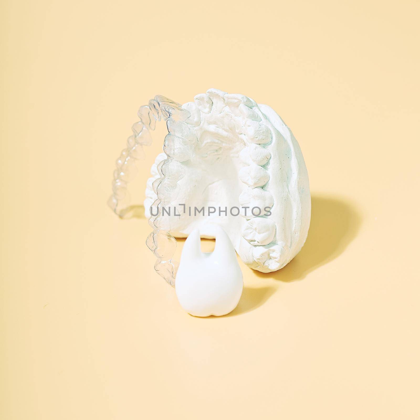 Orthodontic dental theme on  yellow background.Transparent invisible dental aligners or braces aplicable for an orthodontic dental treatment