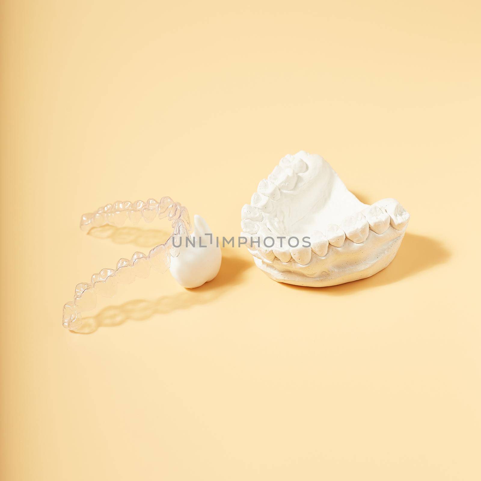 Orthodontic dental theme on  yellow background.Transparent invisible dental aligners or braces aplicable for an orthodontic dental treatment