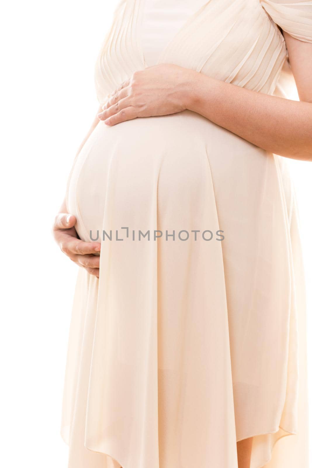 Pregnant woman touching her big belly with love