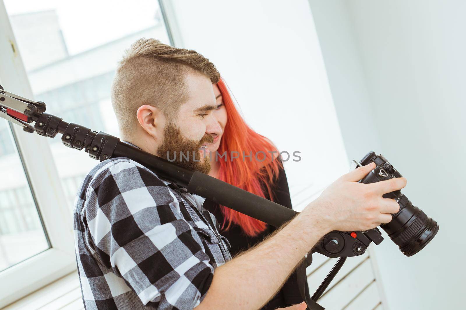 production, shooting advertising and content for social networks - Operator working with a camera on his shoulder and shows the girl footage.