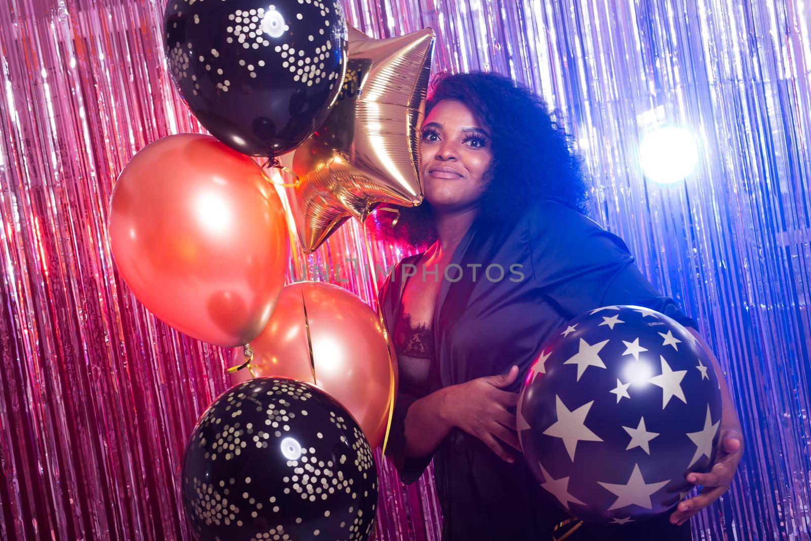 Beautiful black woman enjoying a party lifestyle. Birthday party, clubbing and holidays concept. by Satura86