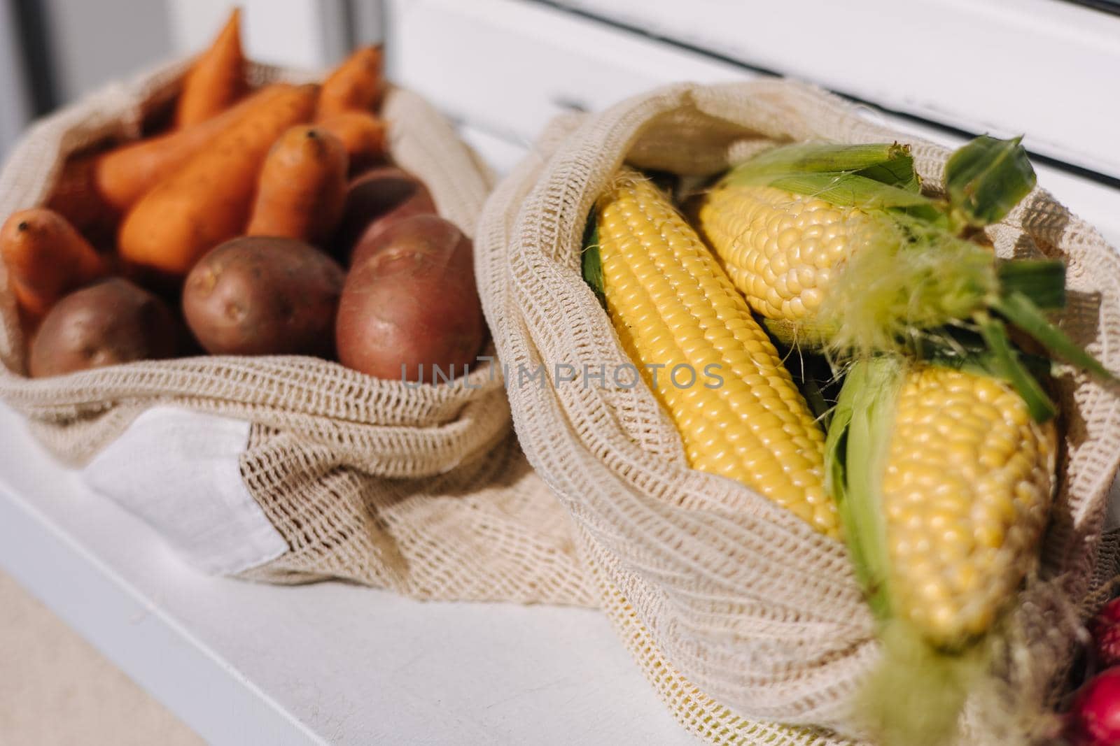 Fresh raw corn in eco canvas grocery bag. Cotton bags with vegetables. Zero waste shopping concept. Plastic free items.