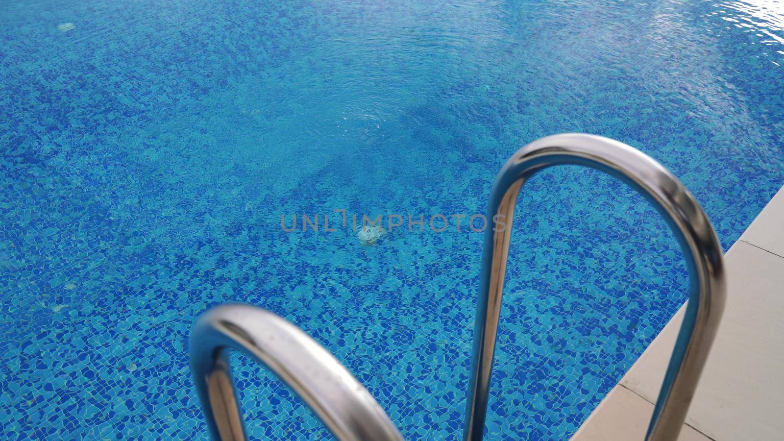 Close-up of the movement of many air bubbles floating on the surface of the water in the pool. Beautiful underwater background