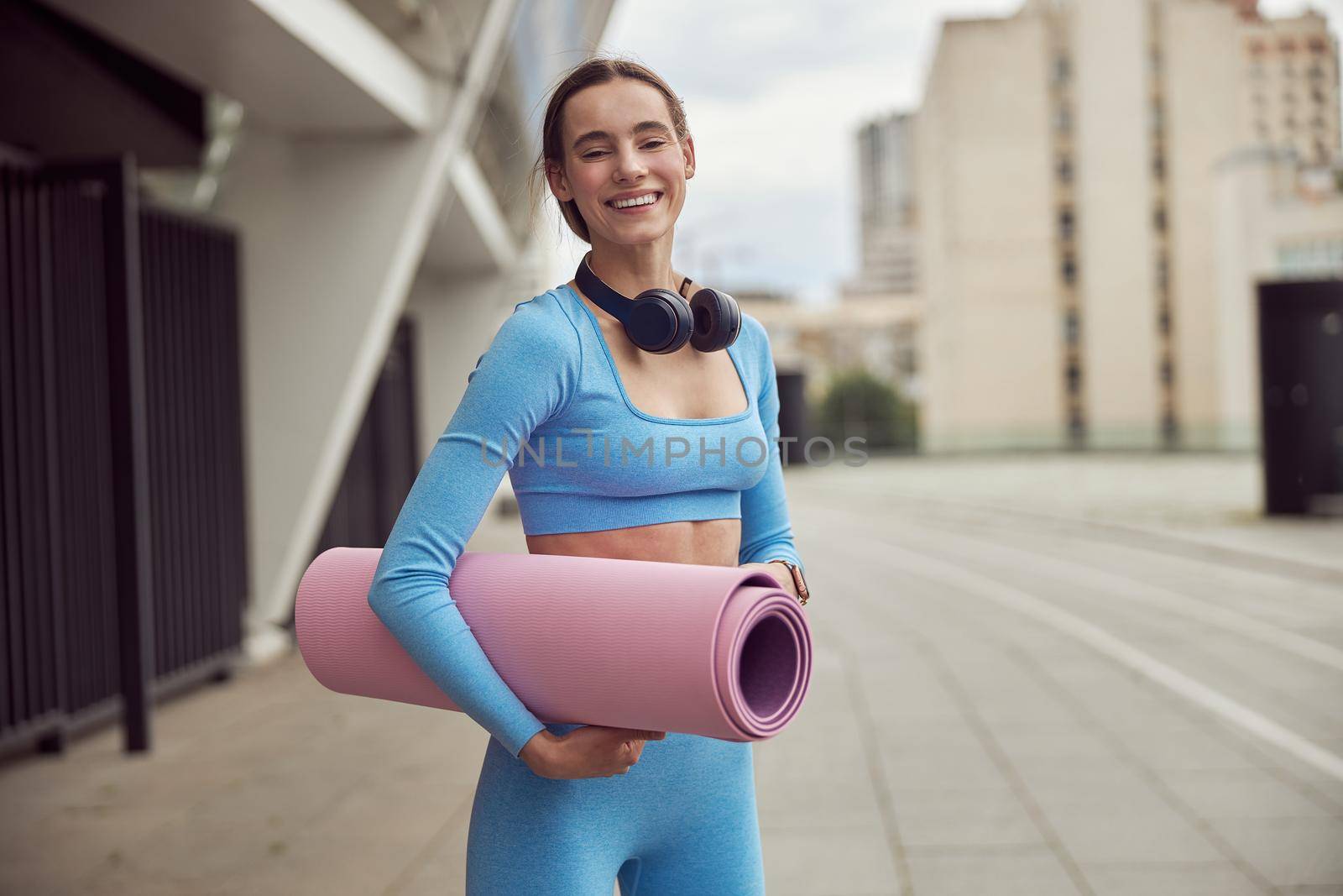 happy beautiful caucasian woman at workout in urban city