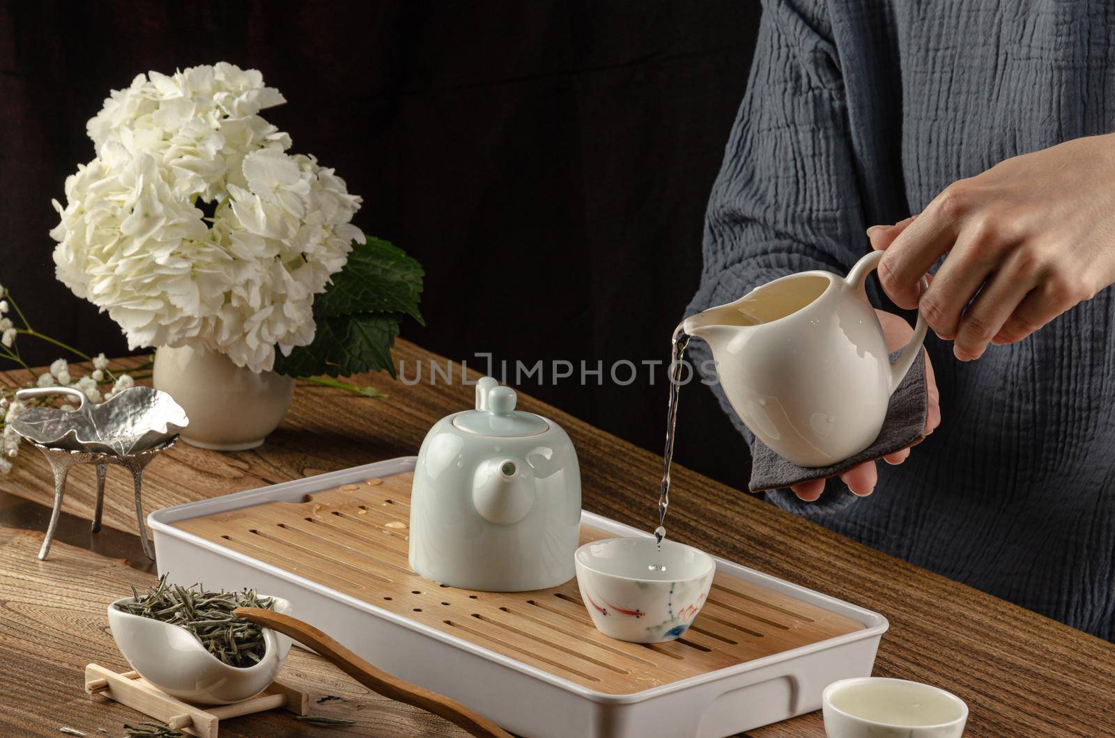 the tea table with instruments teapots cups and green tea by Rotozey