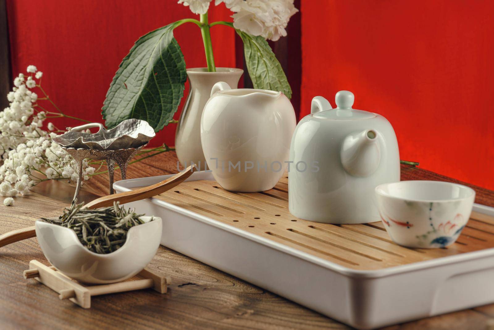 the tea table with instruments teapots cups and green tea by Rotozey