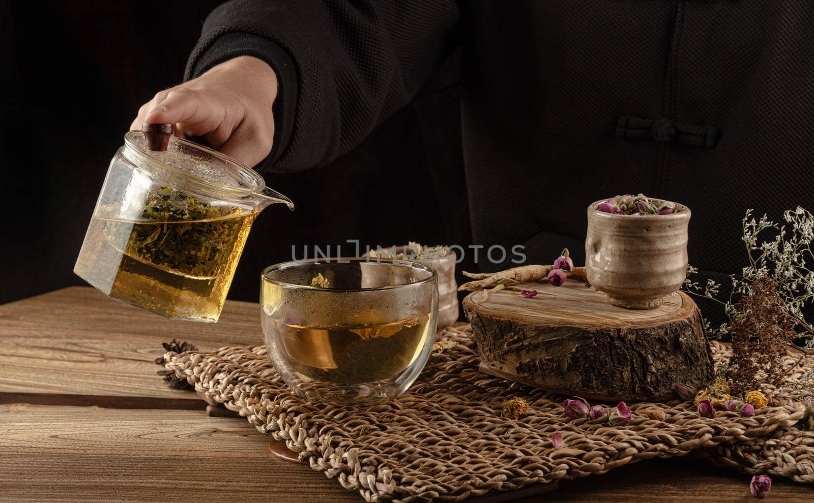 table with herbal tea and rose petals