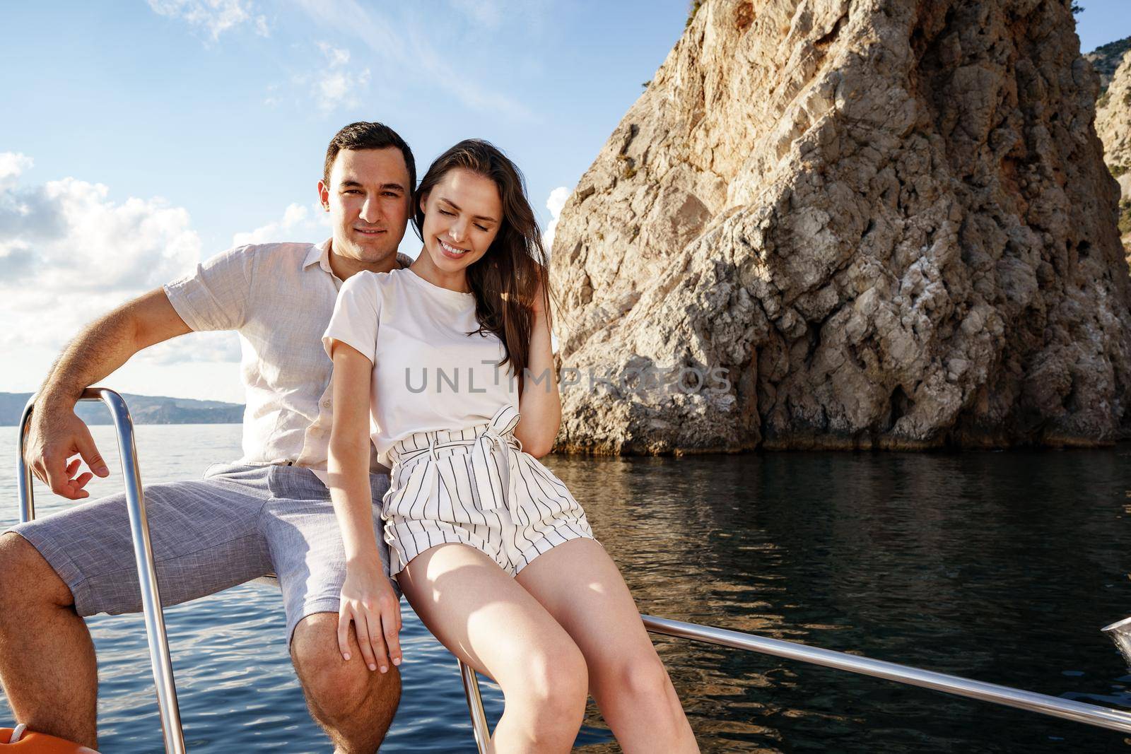 Happy couple in love on a yacht in summer on romantic vacation