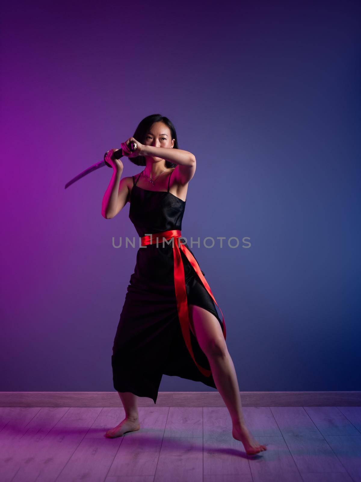 slender Asian woman in a black dress with a katana in her hand image of a samurai on a neon background by Rotozey