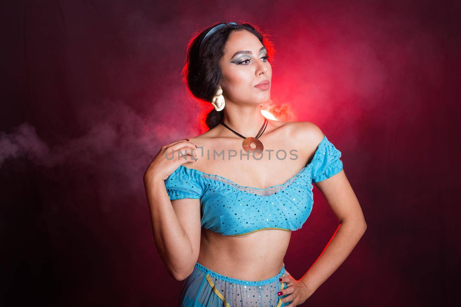 Portrait of a young woman in the image of an Eastern fairy Princess on dark background