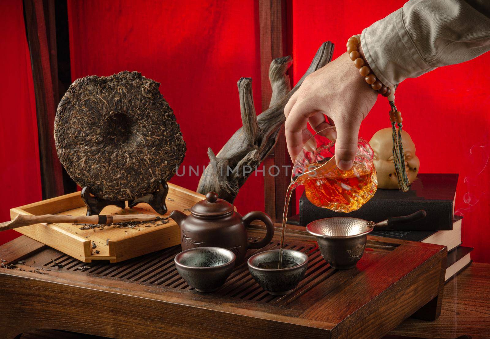 tea table with instruments teapots cups pancake and tea Shen Puer