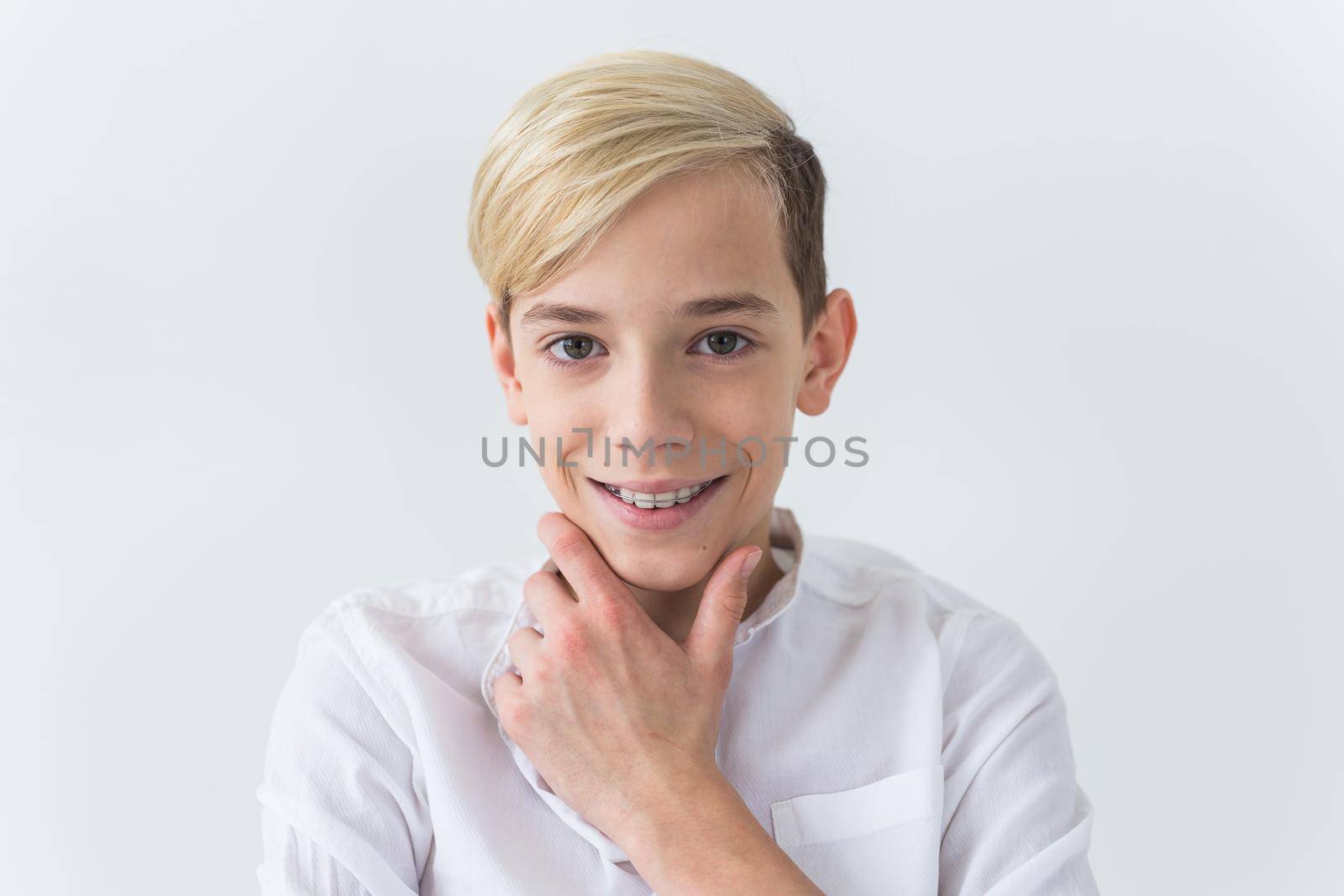 Attractive eleven year old boy with braces on his teeth. Dentistry and teenager