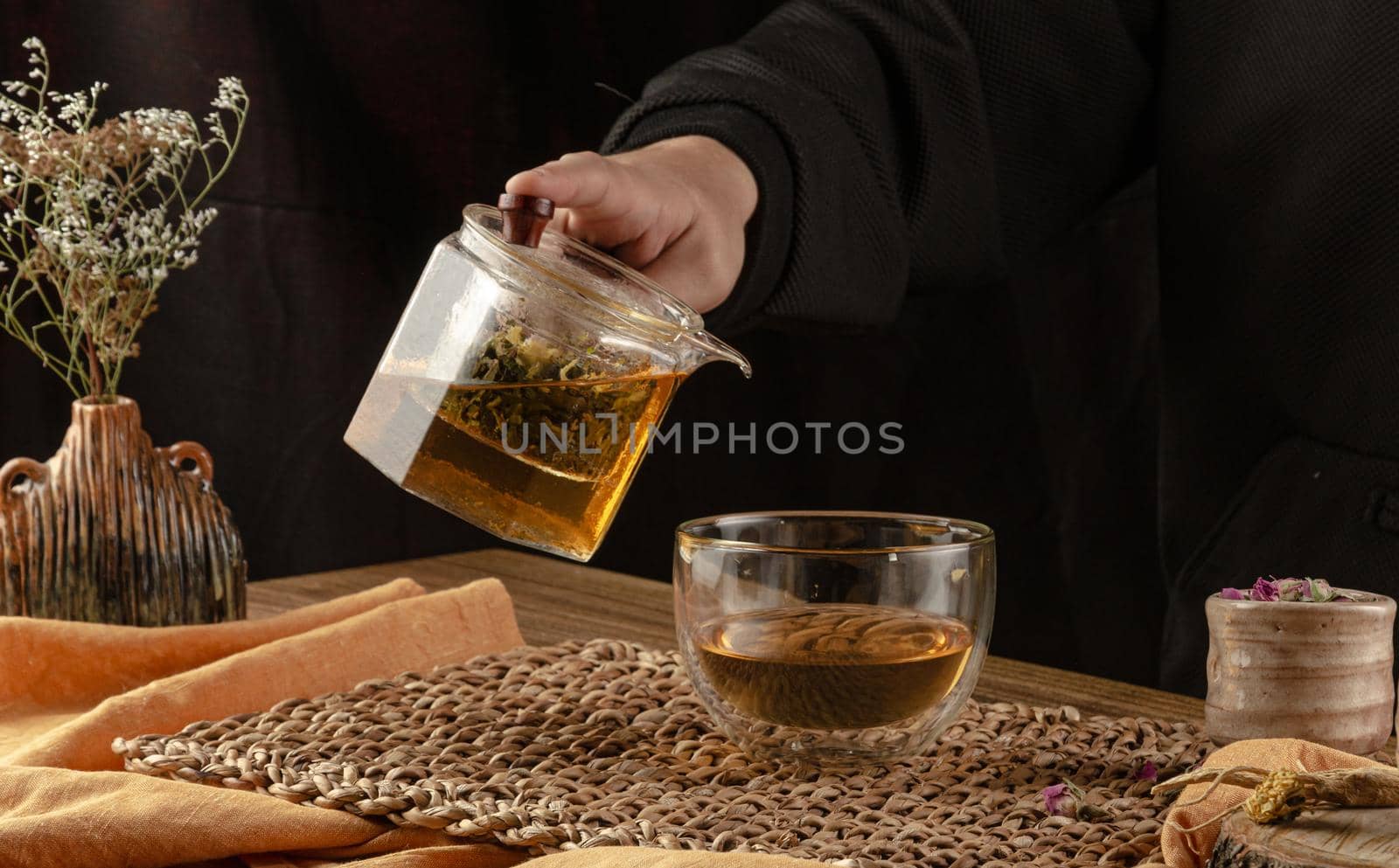 table with herbal tea and rose petals