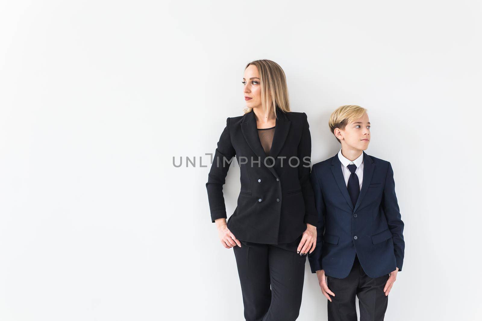 Parenting, family and single parent concept - A happy mother and teen son smiling on white.