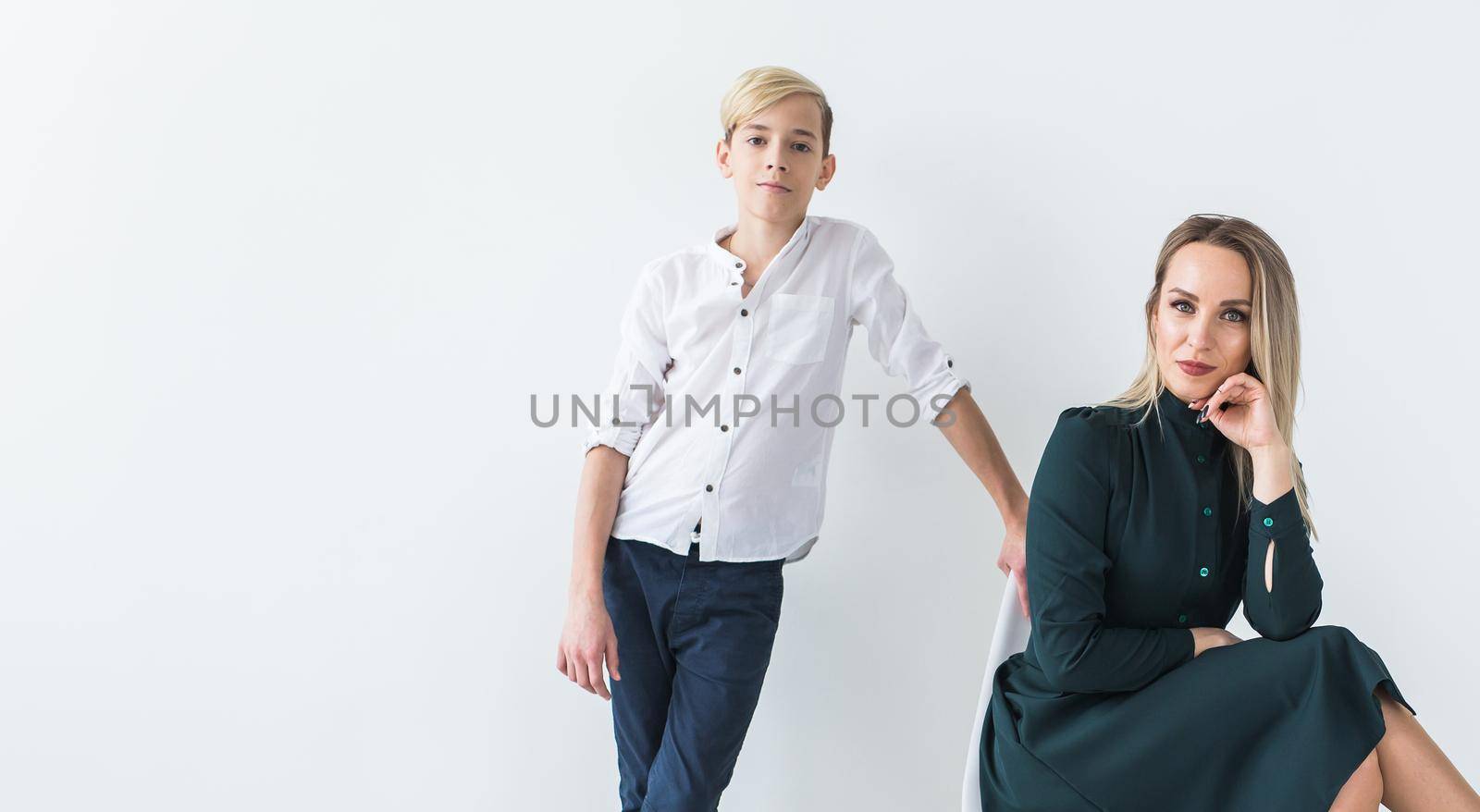 Teenager and single parent - Young mother and son together on white background with copy space. by Satura86