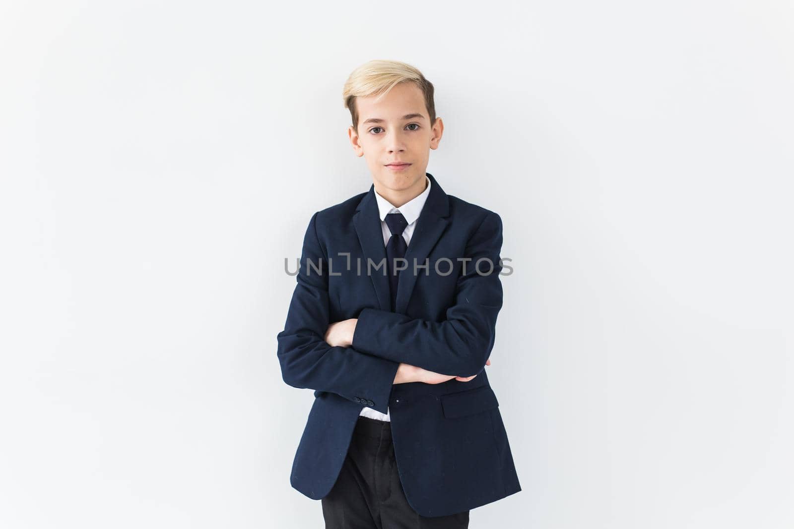 Portrait of stylish school boy teenager in white shirt and jacket against white background. by Satura86