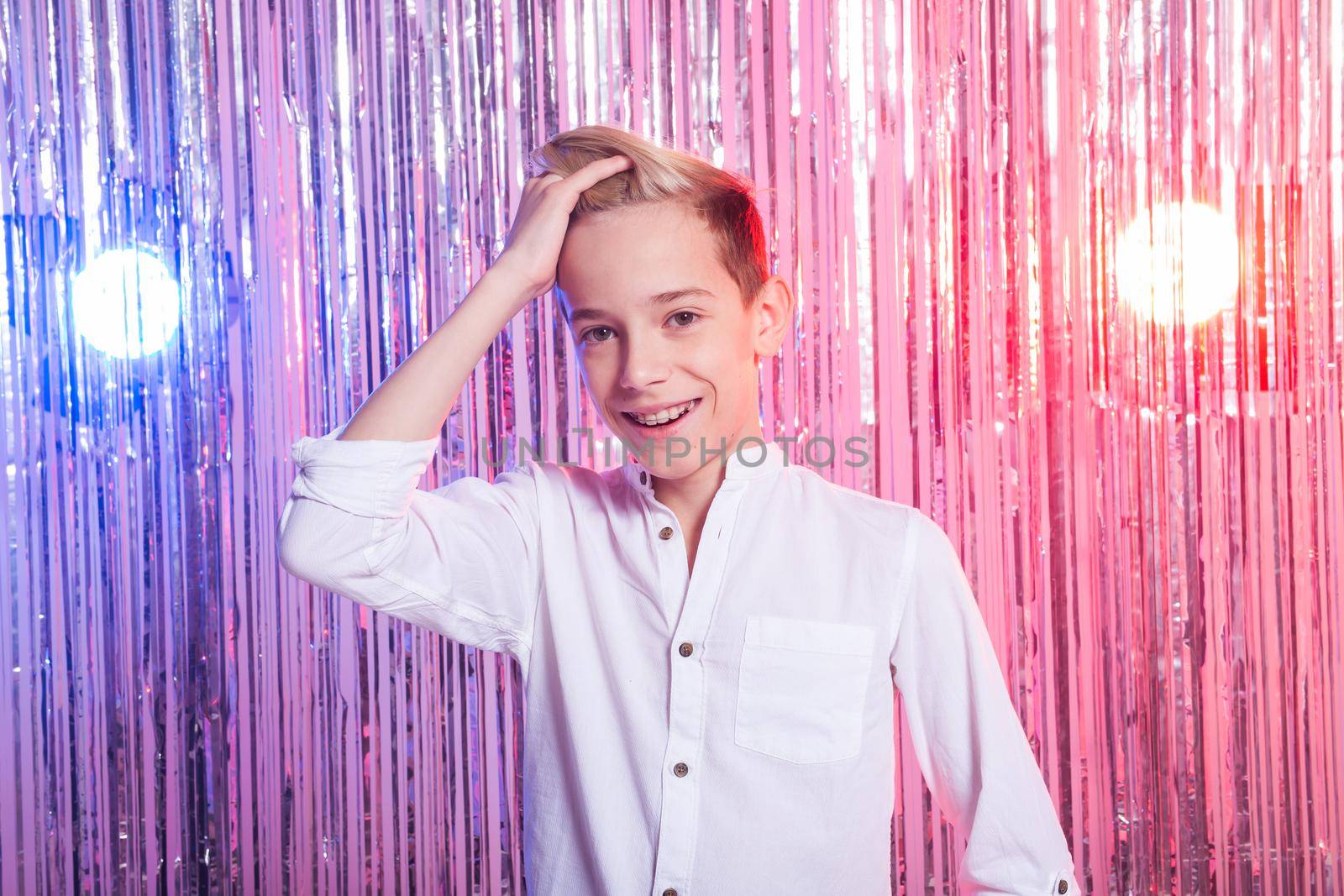 Awkward age and teenage concept - Portrait of teen boy at a party.