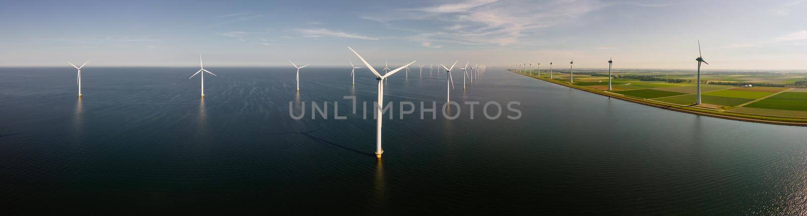 Wind turbine from an aerial view, Drone view at windpark a windmill farm in the lake IJsselmeer the biggest in the Netherlands, Sustainable development, renewable energy. 