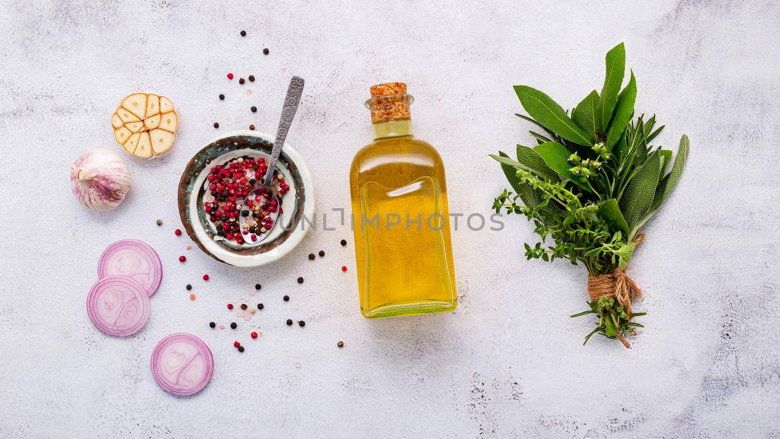 Ingredients for steak seasoning in ceramic bowl set up on white concrete background with copy space.