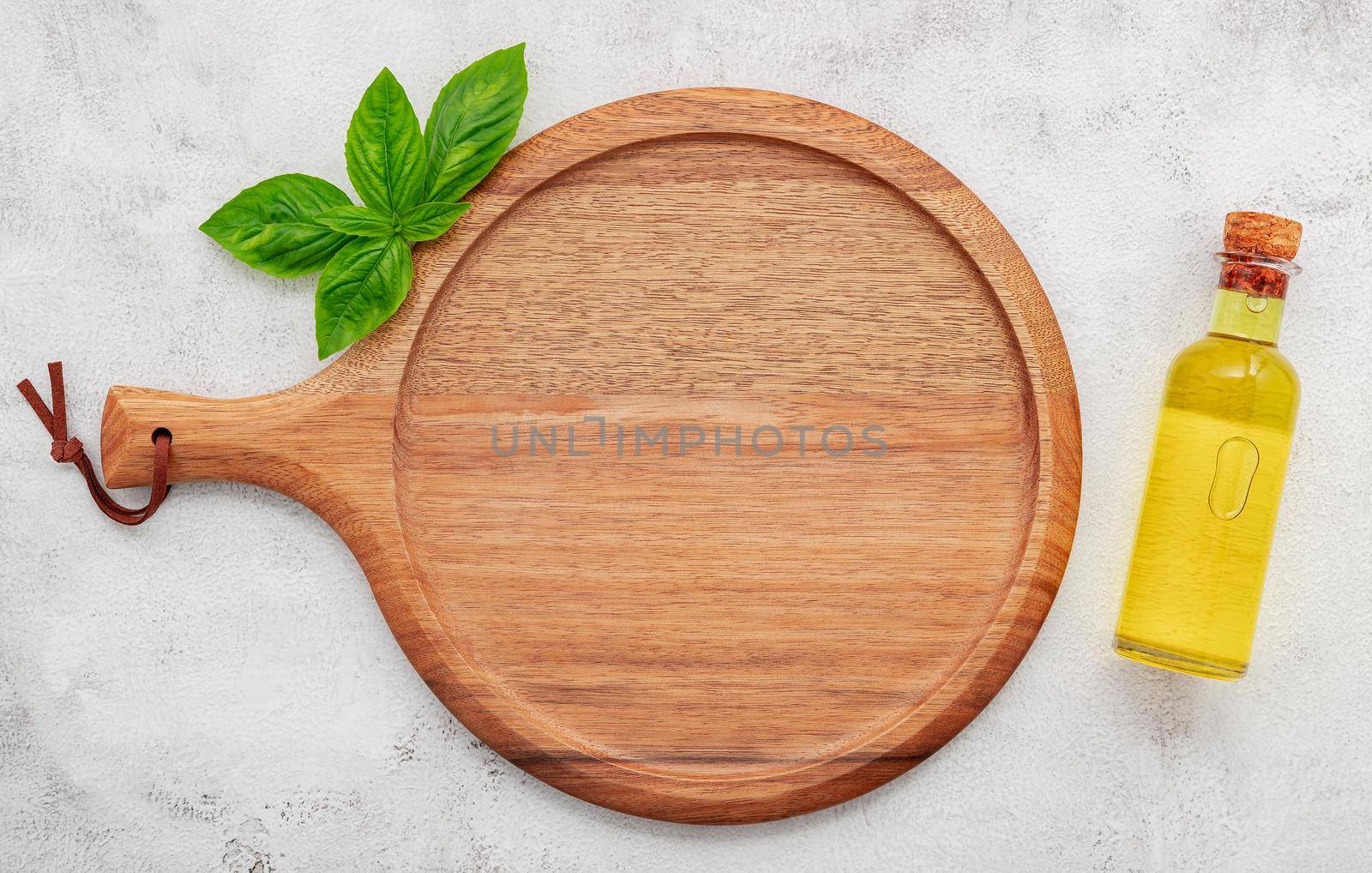 Empty wooden pizza platter set up on white concrete. Pizza tray on white concrete background flat lay and copy space.
 by kerdkanno